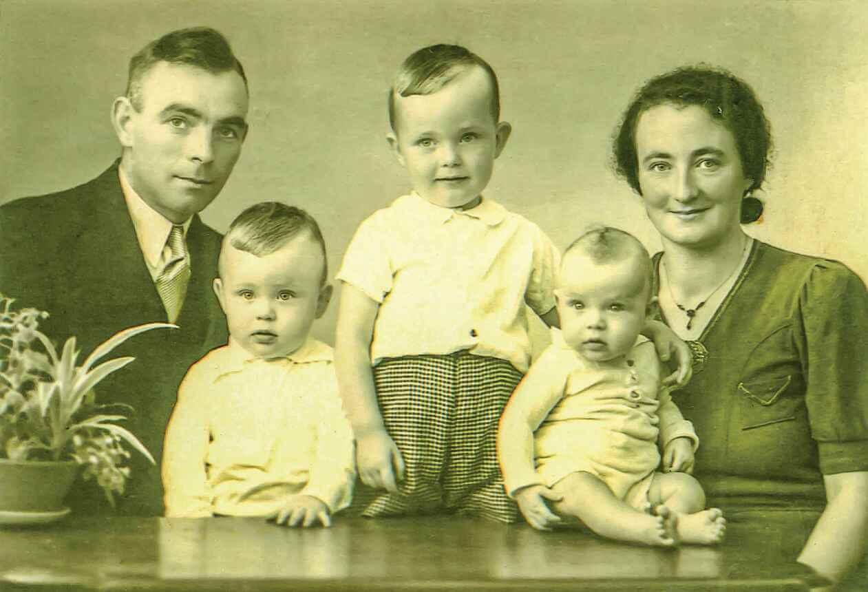 My parents with their first three children. I am standing by my father.