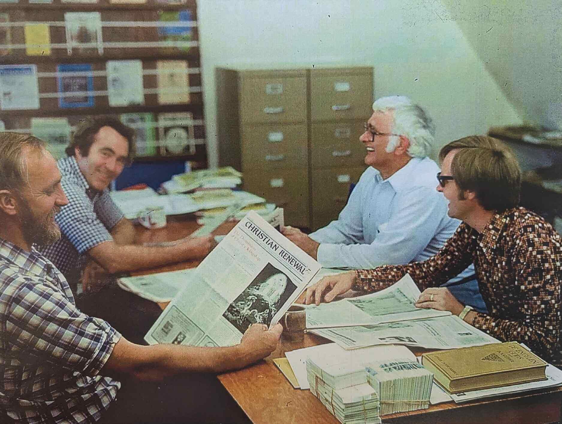 Left to Right: Chuck Dykstra (with beard), John Hultink, John Wynia (white hair), and Jim Antonides (glasses) exam-ining the first issue of Christian Renewal, 1982.